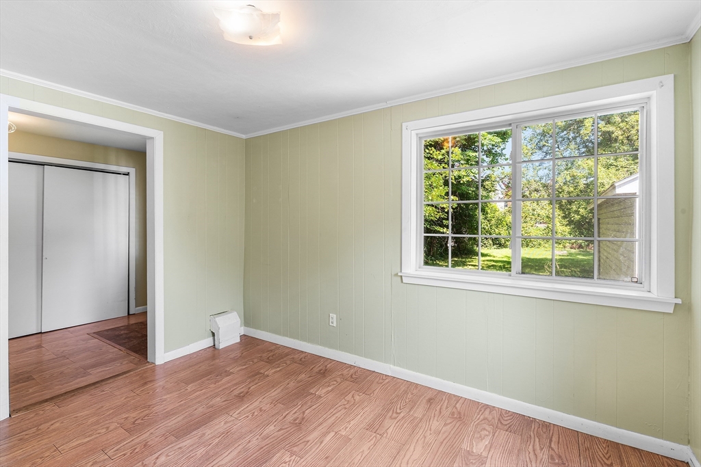 13 Maple Street Easthampton, MA 01027 - Photo 16 of 36 a view of an empty room with wooden floor and a window