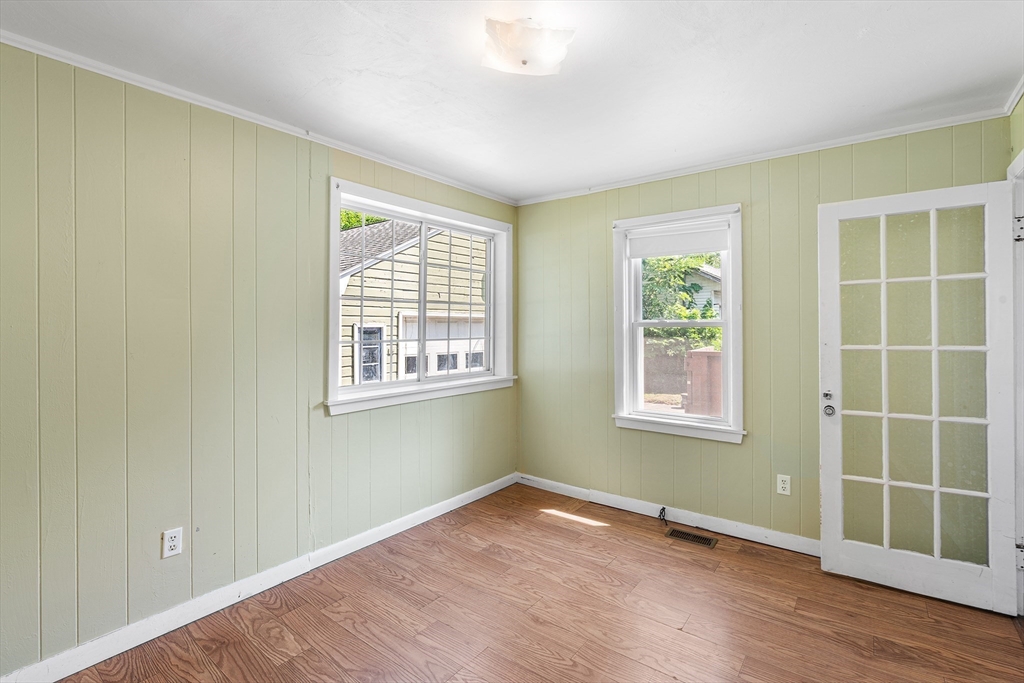 13 Maple Street Easthampton, MA 01027 - Photo 17 of 36 an empty room with wooden floor and windows