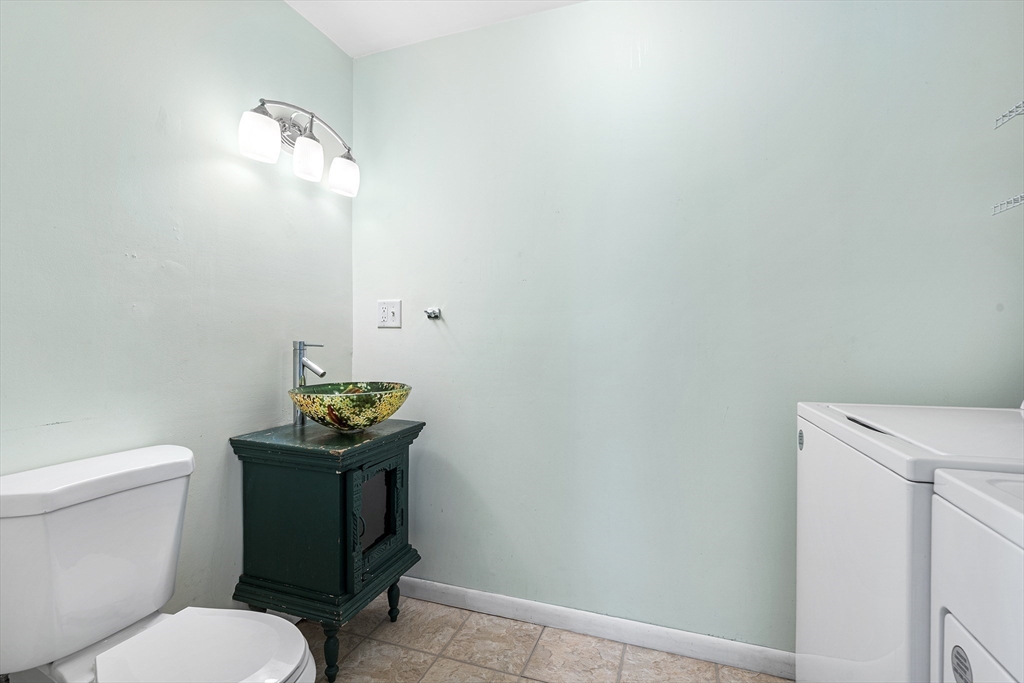 13 Maple Street Easthampton, MA 01027 - Photo 20 of 36 a bathroom with a toilet a sink and wooden floor