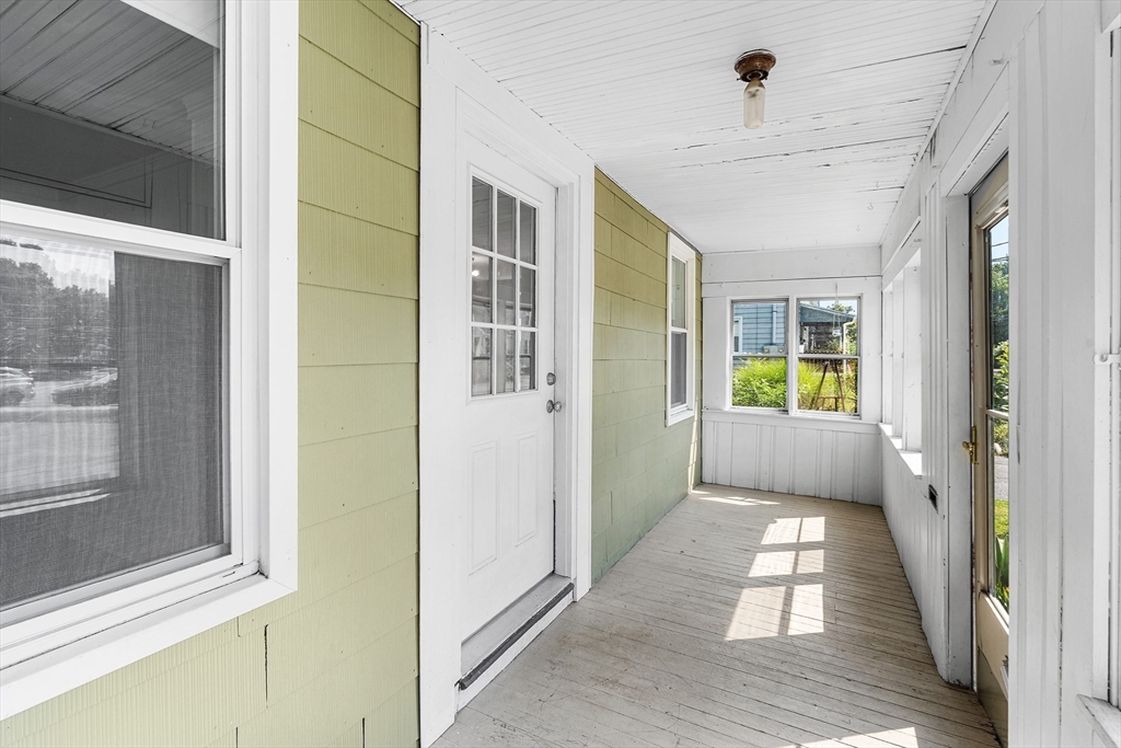 13 Maple Street Easthampton, MA 01027 - Photo 2 of 36 a view of a hallway with furniture and a window