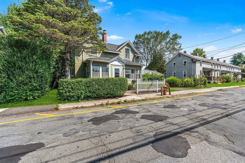 13 Maple Street Easthampton, MA 01027 - Photo 27 of 36 a front view of a house with a yard and potted plants