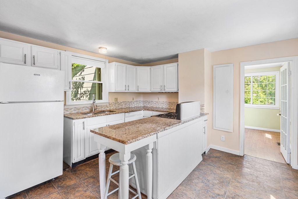 13 Maple Street Easthampton, MA 01027 - Photo 7 of 36 a kitchen with a stove a refrigerator and a sink