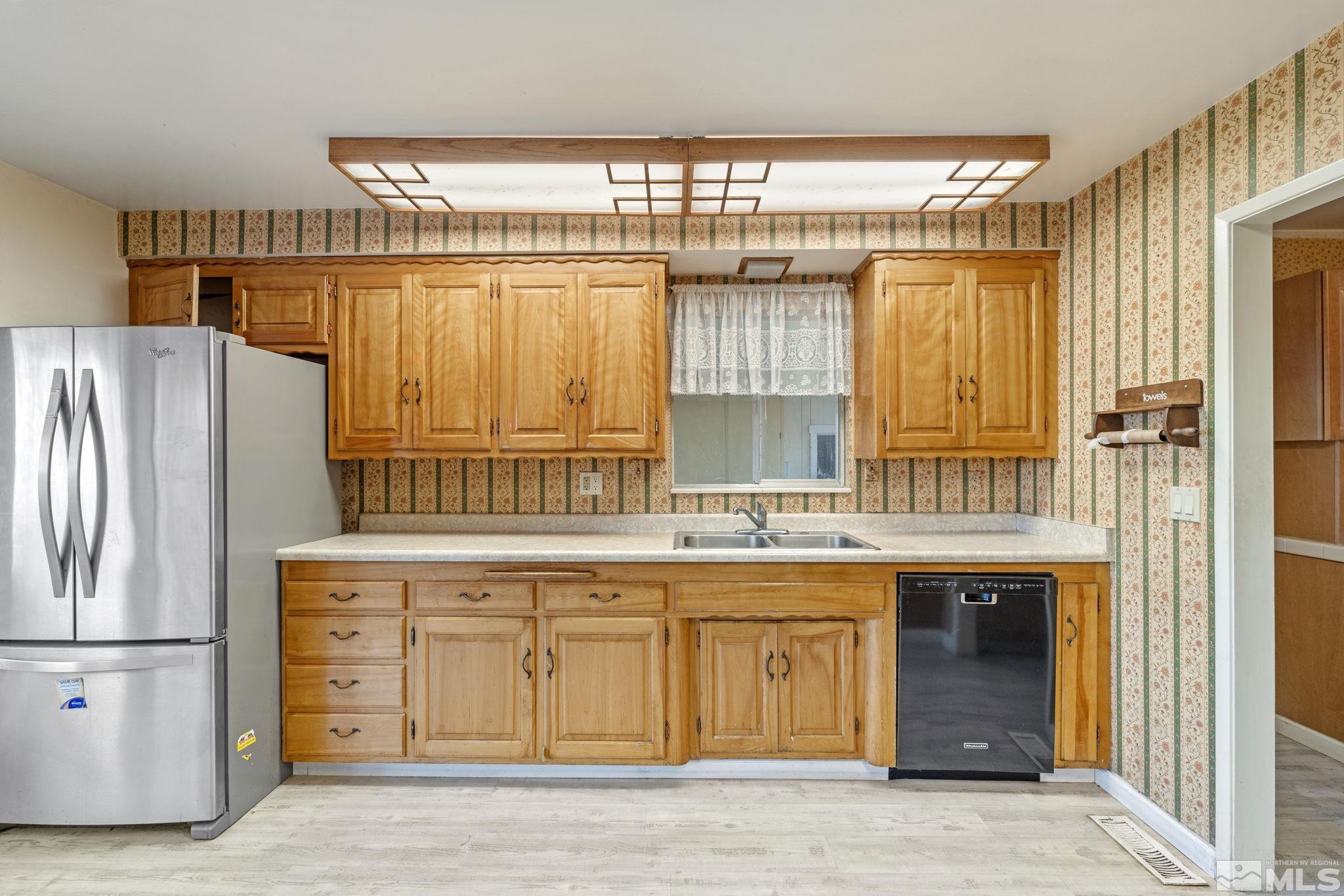1631 Eli Drive Reno, NV 89511 - Photo 14 of 40 a kitchen with stainless steel appliances granite countertop a refrigerator and a sink