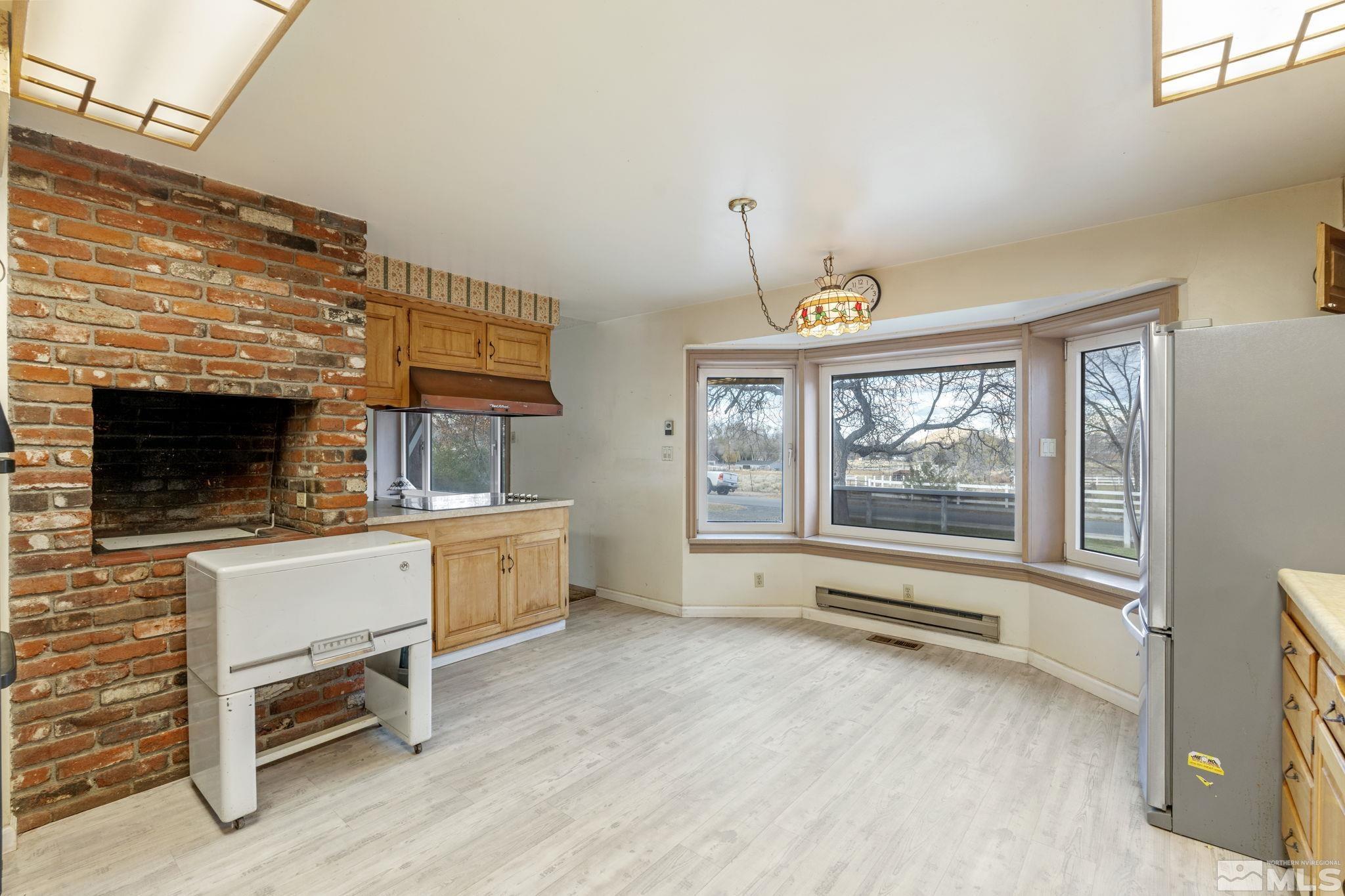 1631 Eli Drive Reno, NV 89511 - Photo 18 of 40 a view of an empty room with a fireplace and a window