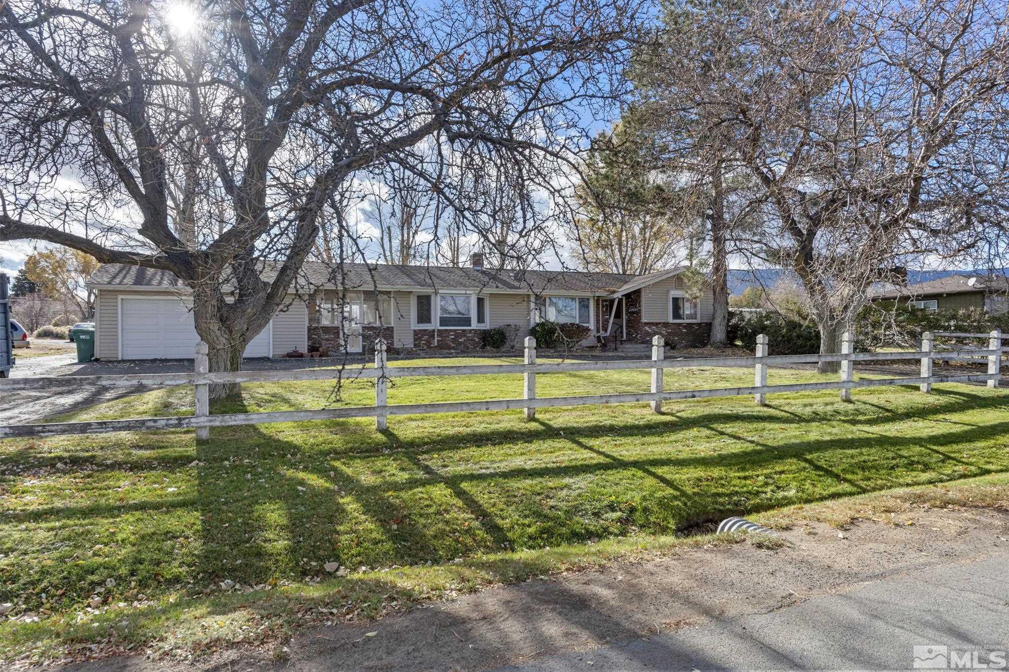 1631 Eli Drive Reno, NV 89511 - Photo 3 of 40 a view of a house with a big yard and large trees