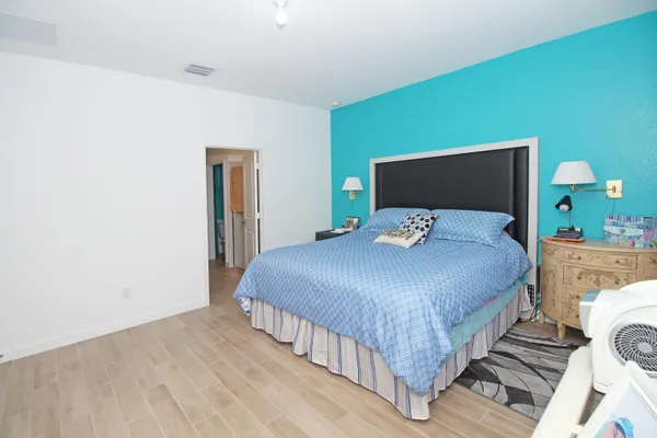 a bedroom with a bed and a dresser