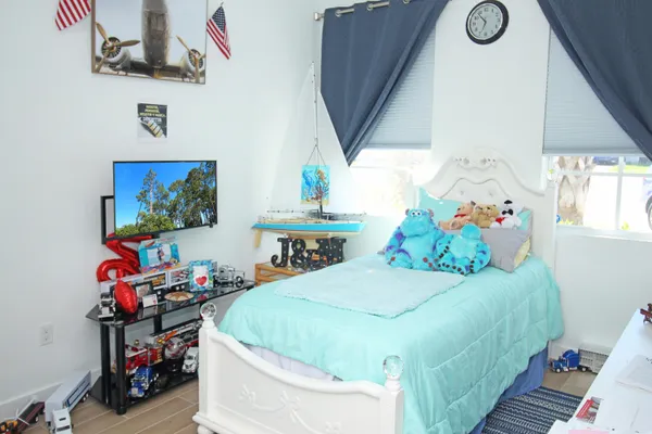 a bedroom with a bed and a window
