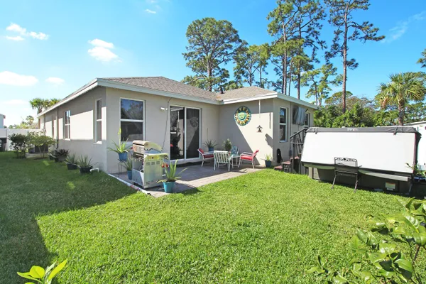 a view of a house with backyard sitting area and garden