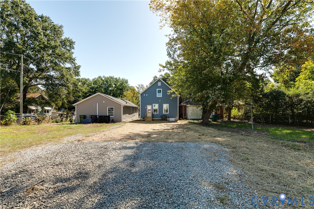 3601.5 Decatur Street Richmond, VA 23224 - Photo 31 of 32 Gravel parking area leading to a blue siding resid