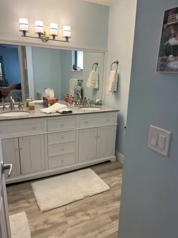 a bathroom with a granite countertop sink and a mirror
