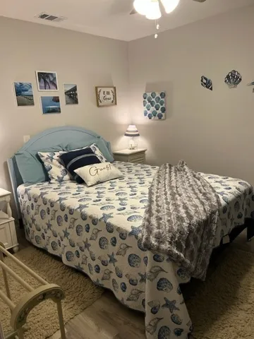 a bedroom with a bed and painting on the wall