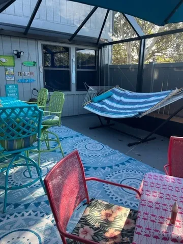 a backyard of a house with barbeque oven table and chairs
