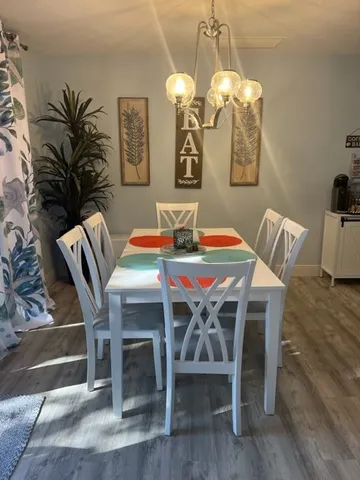 a view of a dining room with furniture and wooden floor