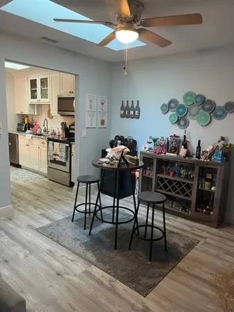 a dining room with furniture and wooden floor