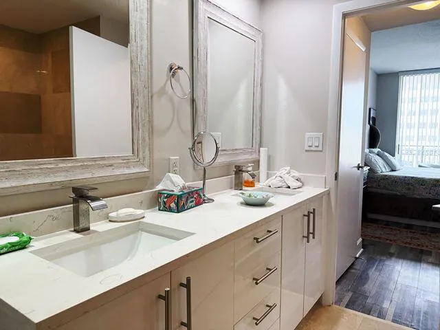 a bathroom with a double vanity sink and mirror