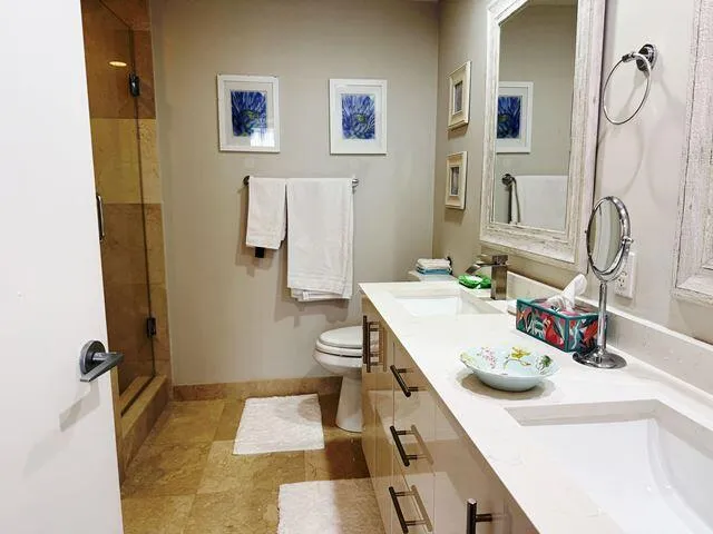 a bathroom with a sink vanity mirror and toilet