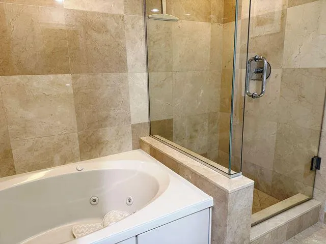 a bathroom with a tub and a shower