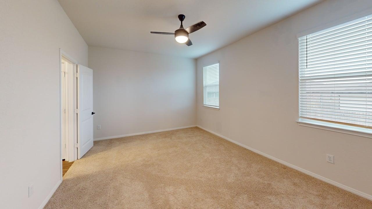 245 Brooklyn Drive Georgetown, TX 78626 - Photo 11 of 23 Empty room with light carpet and a ceiling fan