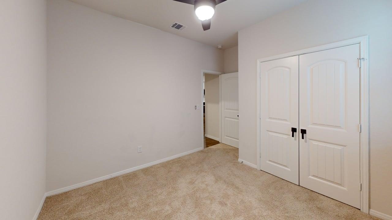 245 Brooklyn Drive Georgetown, TX 78626 - Photo 14 of 23 Unfurnished bedroom with light carpet, a closet, and a ceiling fan