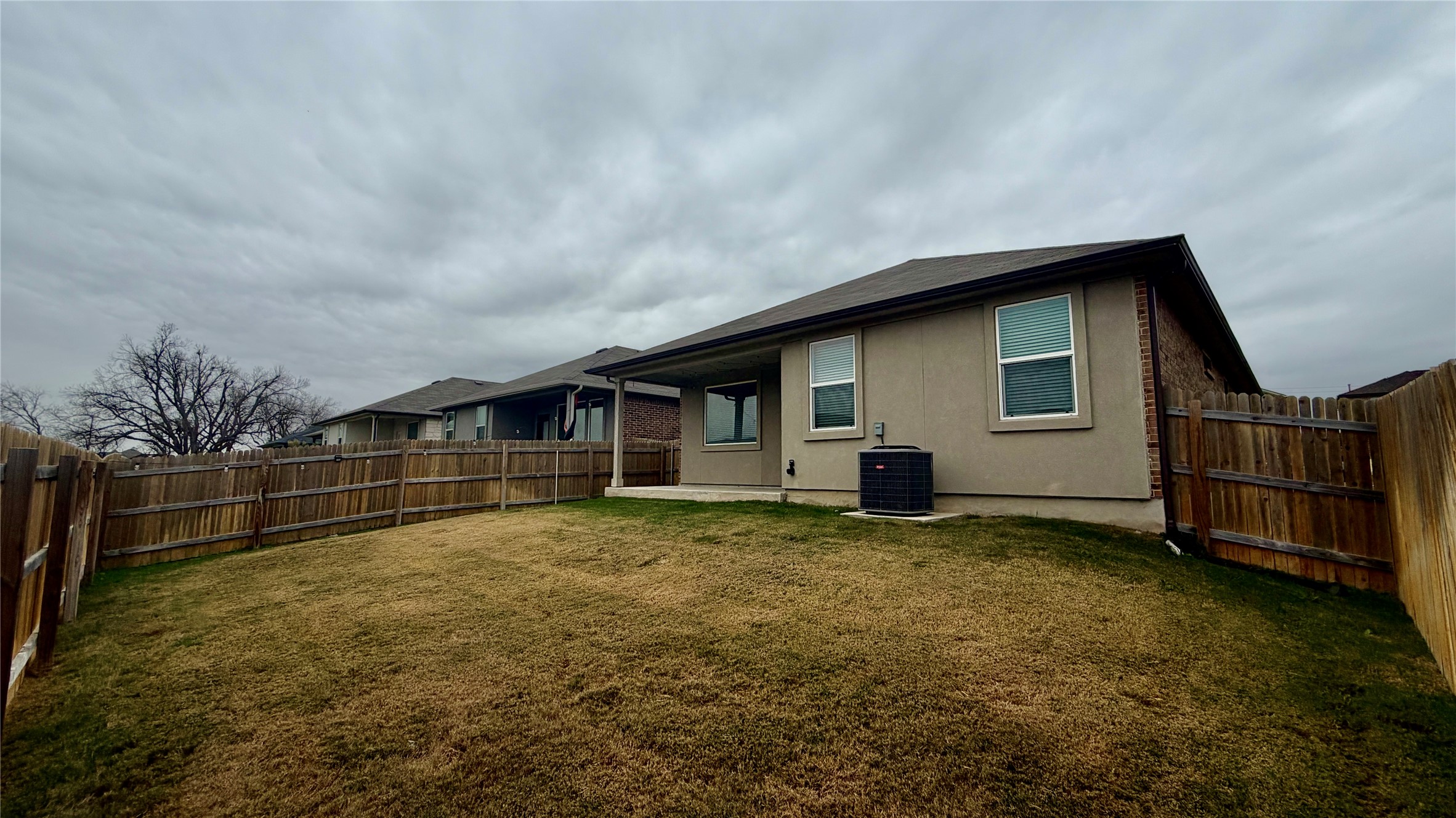 245 Brooklyn Drive Georgetown, TX 78626 - Photo 20 of 23 Rear view of house featuring a patio area, a fenced backyard, and stucco siding