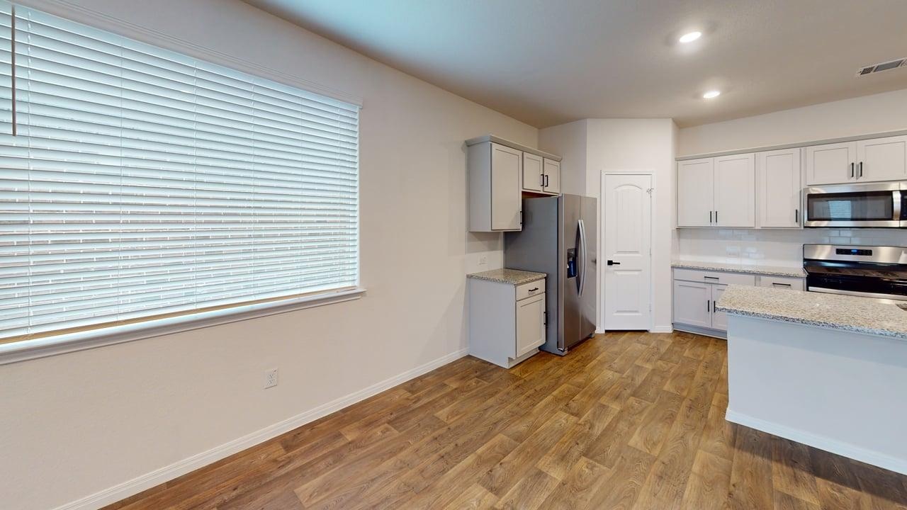 245 Brooklyn Drive Georgetown, TX 78626 - Photo 5 of 23 Kitchen featuring appliances with stainless steel finishes, light wood-style floors, light stone countertops, recessed lighting, and white cabinets