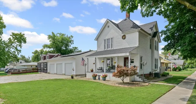 a front view of a house with a yard garden and patio