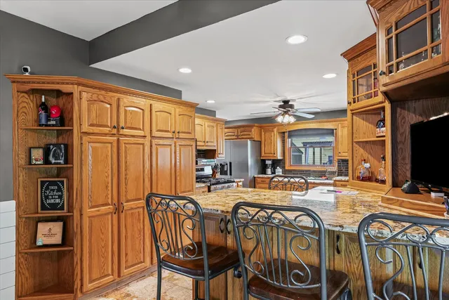 a kitchen with granite countertop a sink a counter and cabinets