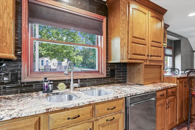 a dining room with furniture a chandelier and wooden floor