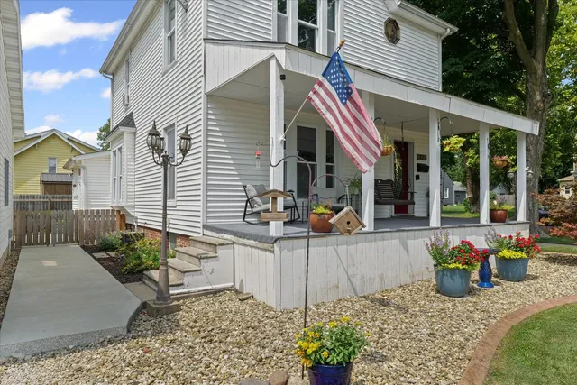 a view of a house with a yard patio and sitting area