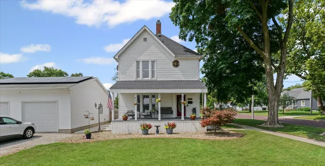 a view of a porch with chairs and potted plants