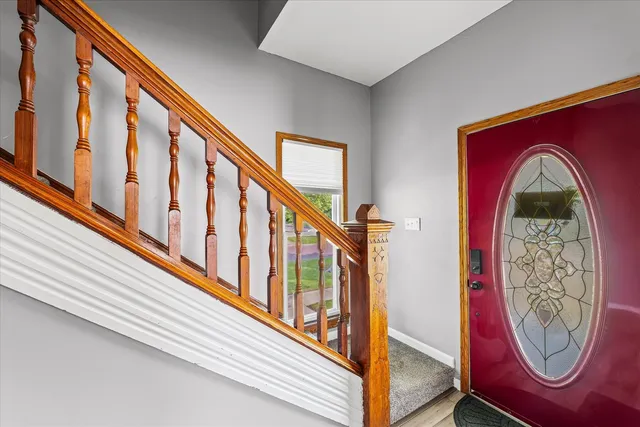 a kitchen with stainless steel appliances granite countertop a stove top oven a sink a dining table and chairs