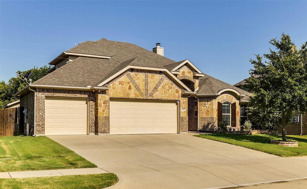 5809 Yellow Rose Court Midlothian, TX 76065 - Photo 1 of 33 Brick and stone exterior featuring varied rooflines, a two-car garage, an arched entryway, a concrete driveway, and mature landscaping