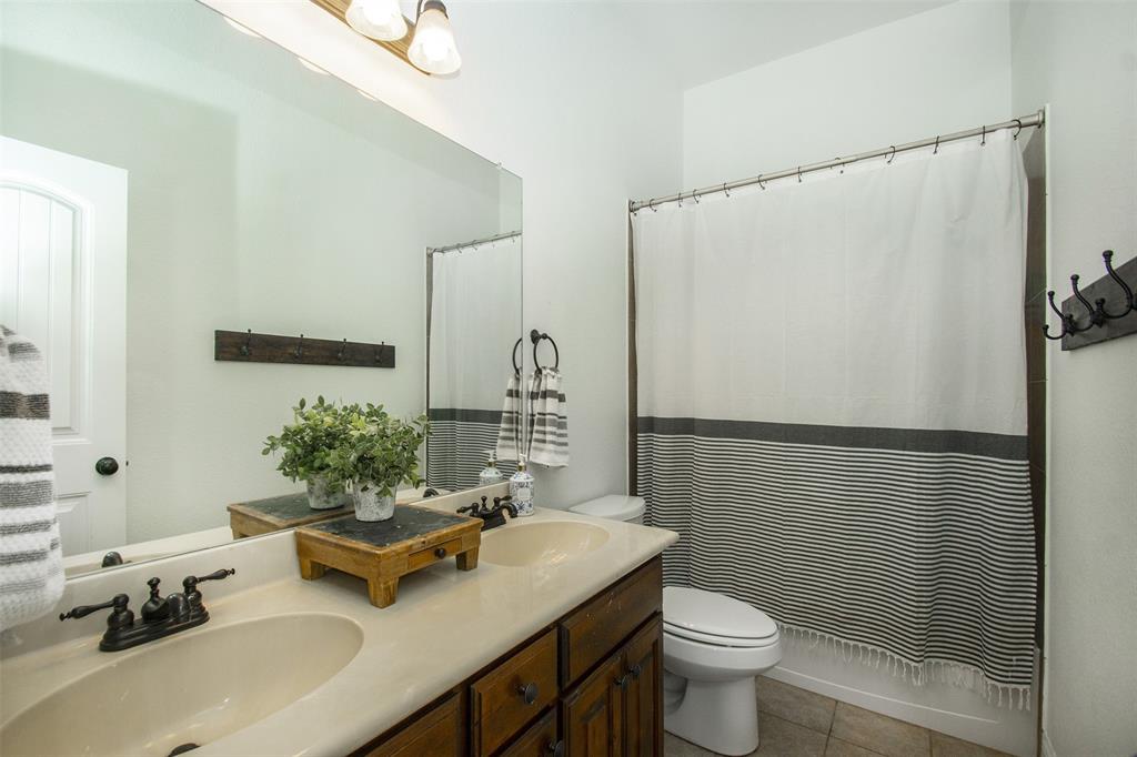 5809 Yellow Rose Court Midlothian, TX 76065 - Photo 18 of 33 Bathroom featuring a double vanity with integrated sinks and dark bronze fixtures