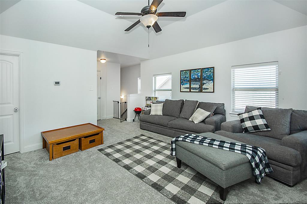 5809 Yellow Rose Court Midlothian, TX 76065 - Photo 23 of 33 Vaulted ceiling with a ceiling fan, carpeted flooring, and multiple windows with blinds