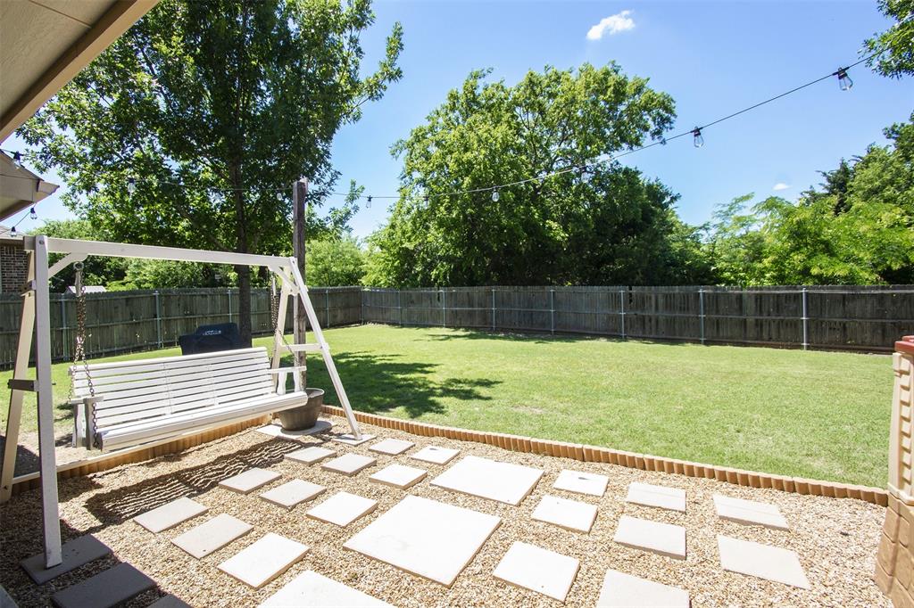 5809 Yellow Rose Court Midlothian, TX 76065 - Photo 28 of 33 Expansive backyard featuring a lush lawn, privacy fencing, and mature trees