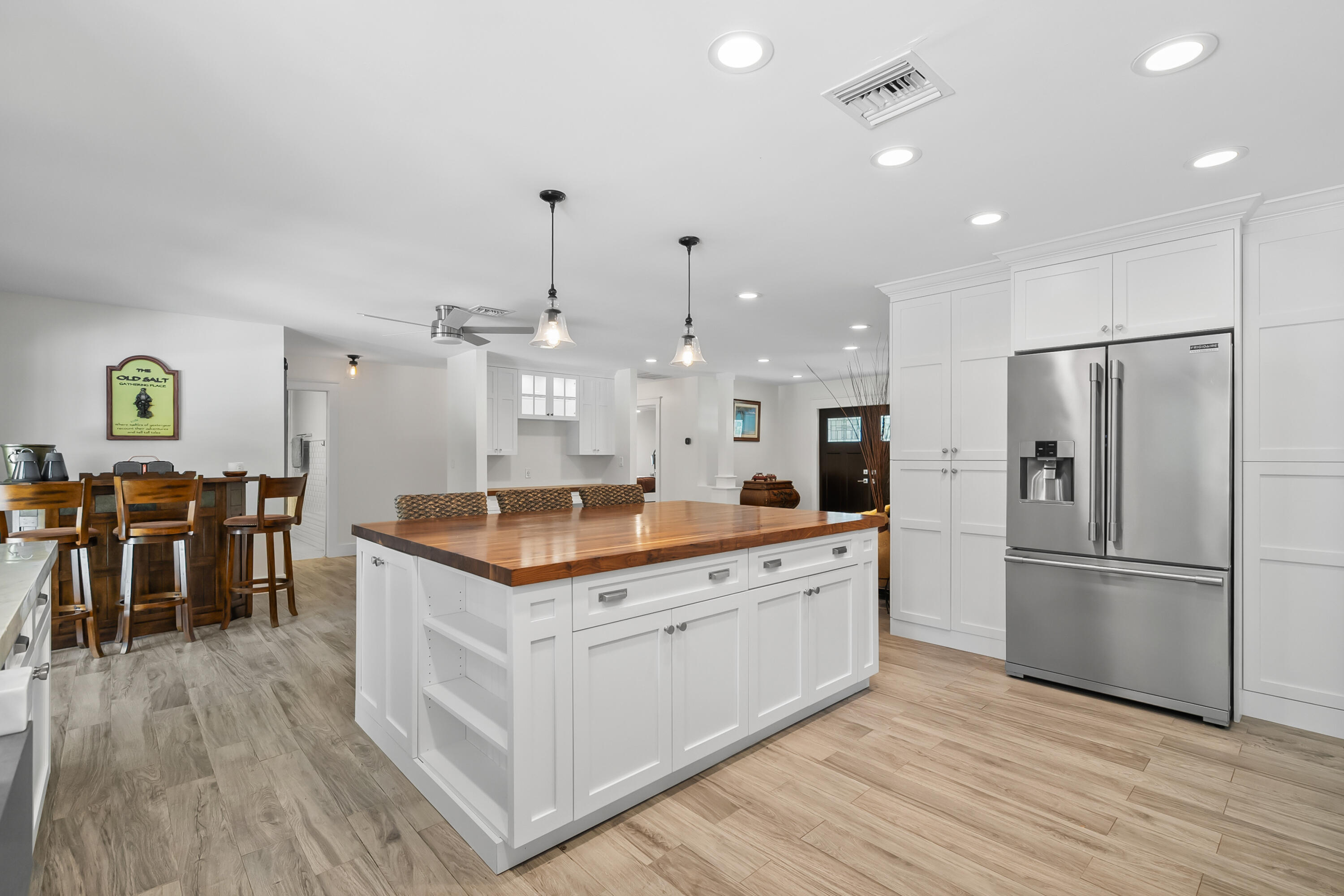 3 Mandalay Road Sewall's Point, FL 34996 - Photo 13 of 46 a kitchen with granite countertop a refrigerator a stove and a wooden floors