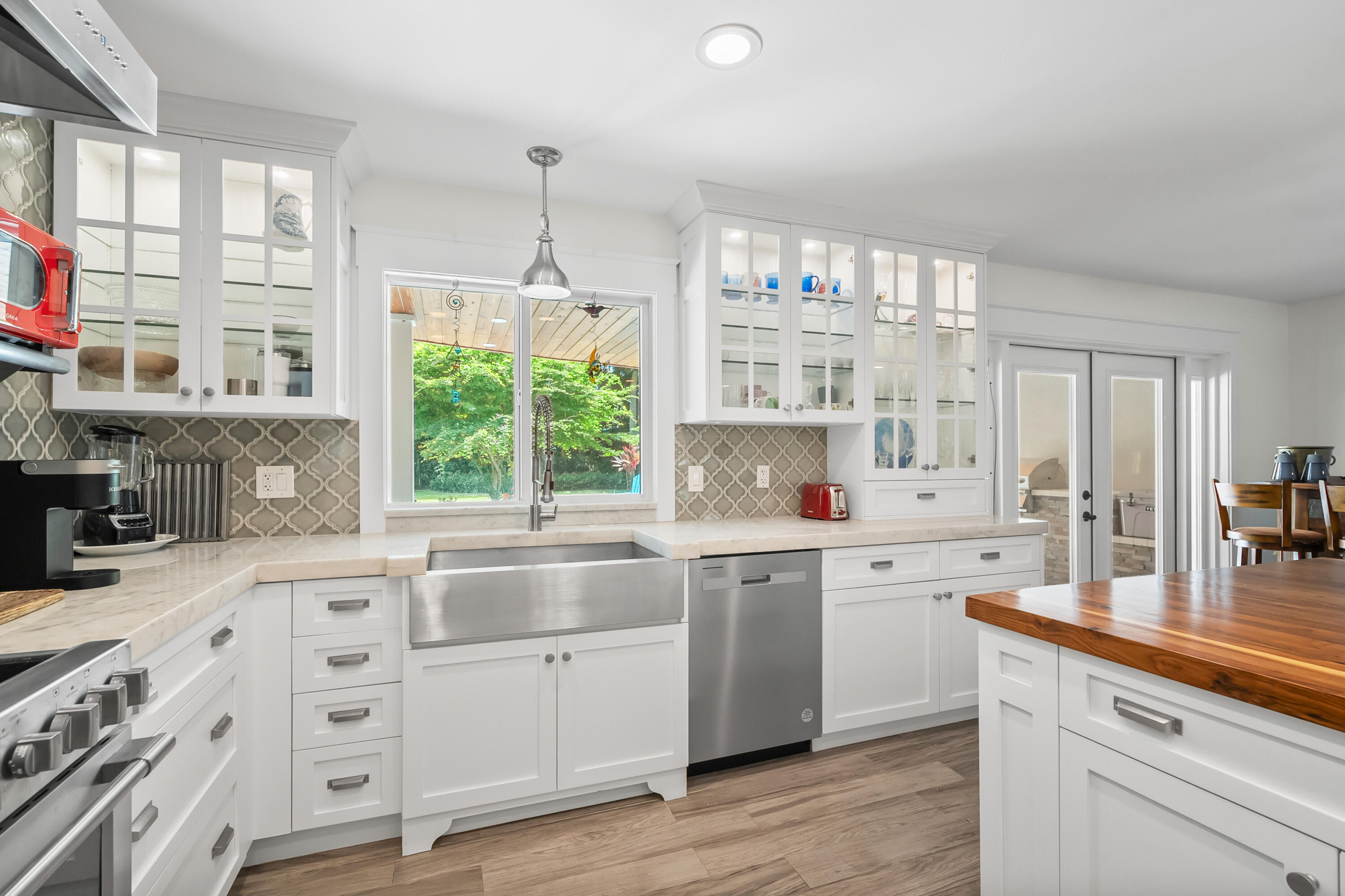 3 Mandalay Road Sewall's Point, FL 34996 - Photo 14 of 46 a kitchen that has a lot of white cabinets and wooden floor