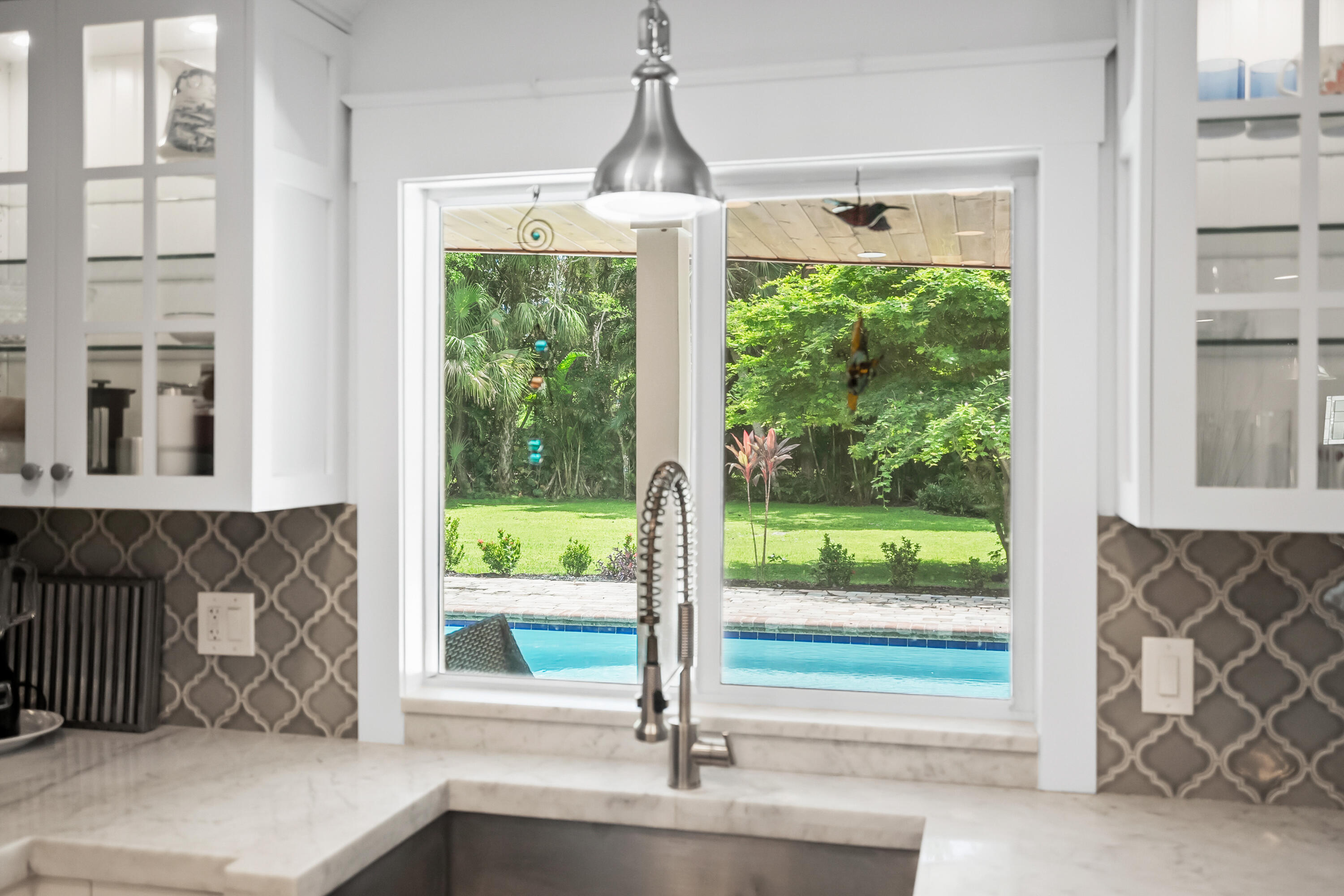 3 Mandalay Road Sewall's Point, FL 34996 - Photo 15 of 46 a front view of a house with a porch