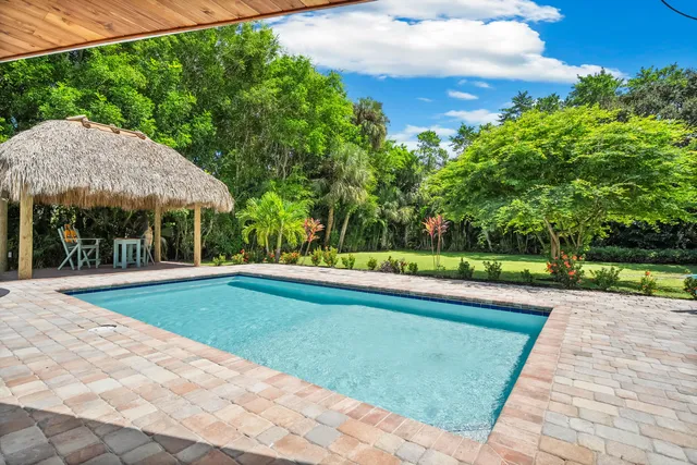 a view of a swimming pool with a yard