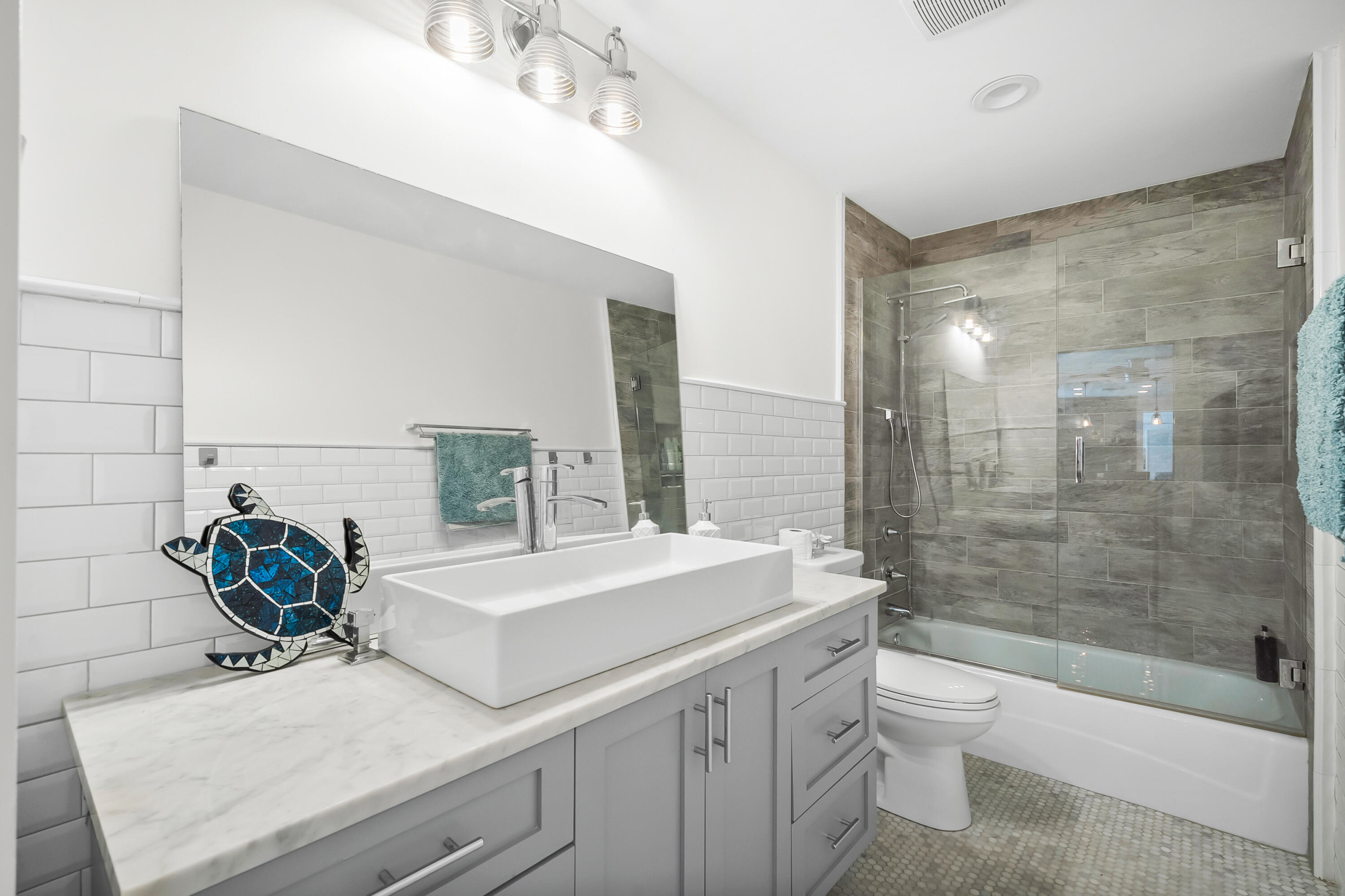 3 Mandalay Road Sewall's Point, FL 34996 - Photo 23 of 46 a bathroom with a sink a toilet and shower