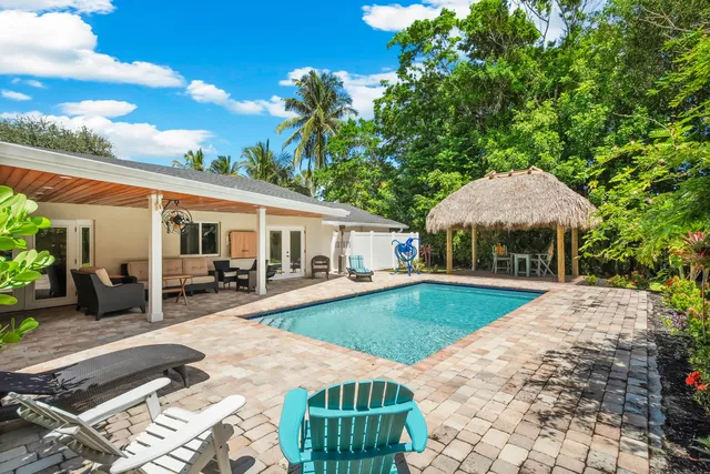 a view of a green field with house in the background
