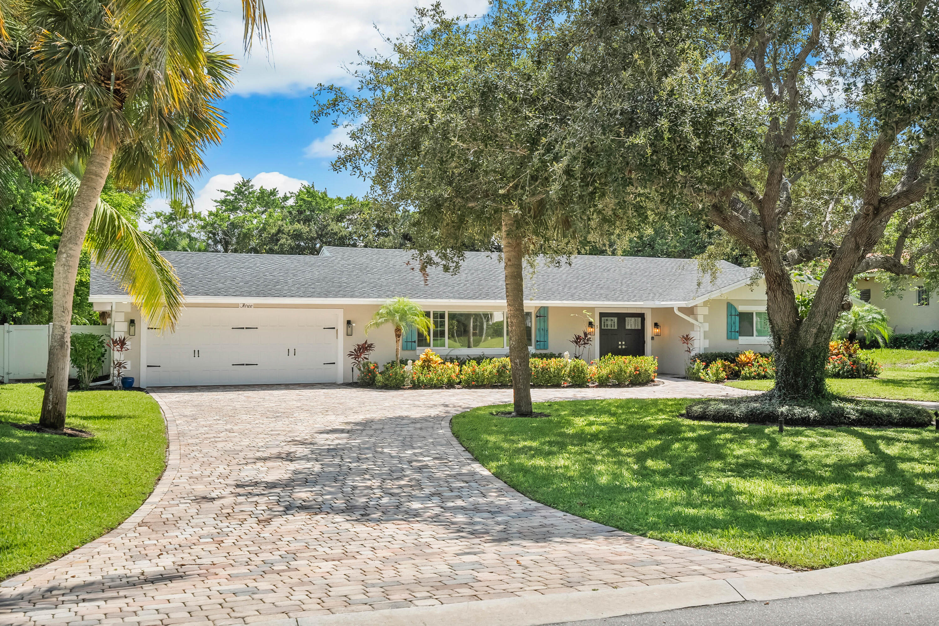 3 Mandalay Road Sewall's Point, FL 34996 - Photo 35 of 46 a front view of a house with a yard and potted plants