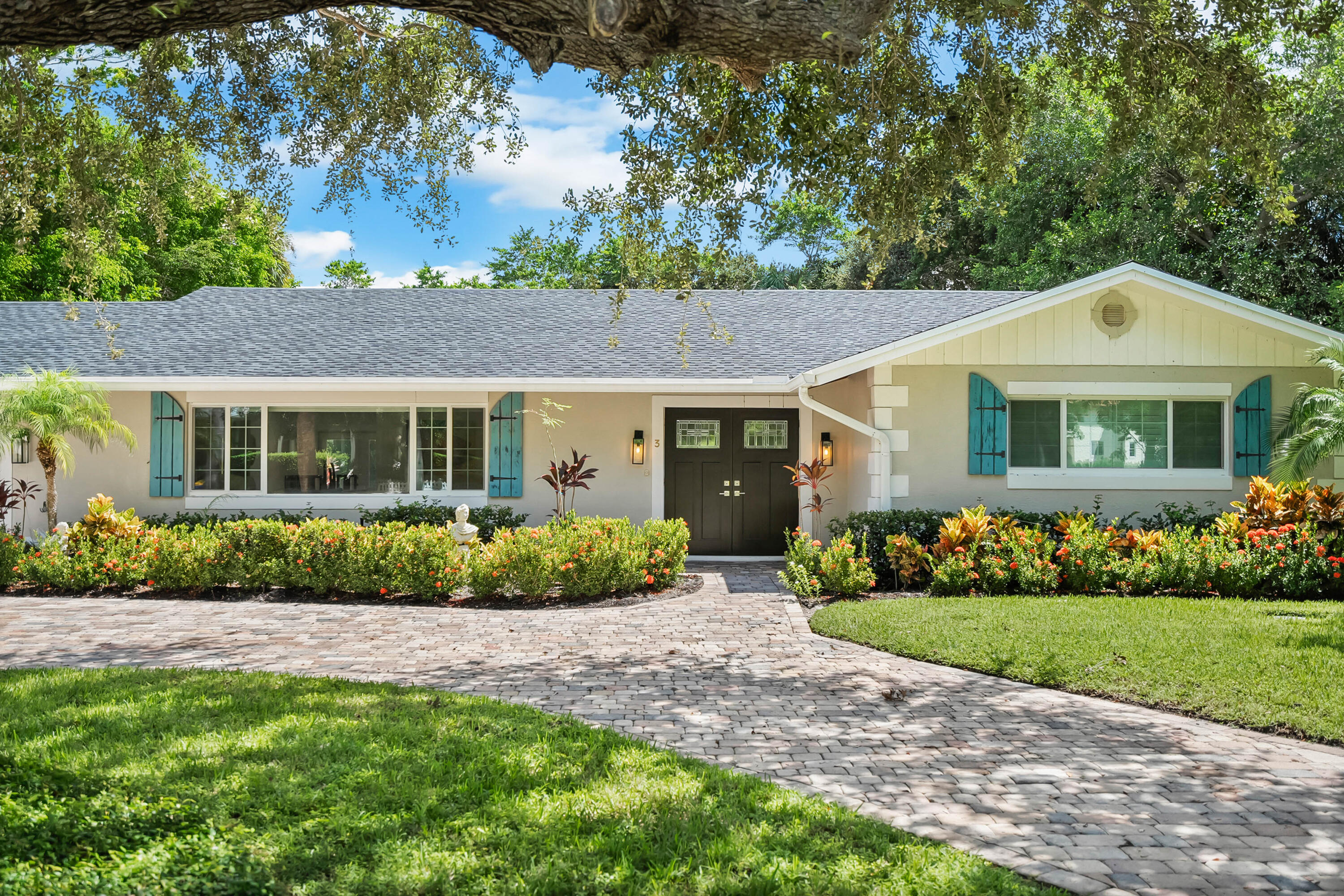 3 Mandalay Road Sewall's Point, FL 34996 - Photo 37 of 46 a front view of a house with a garden and plants
