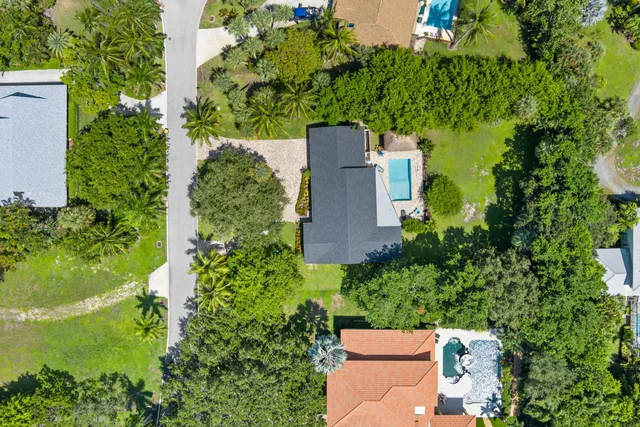 an aerial view of a house with a yard and lake view