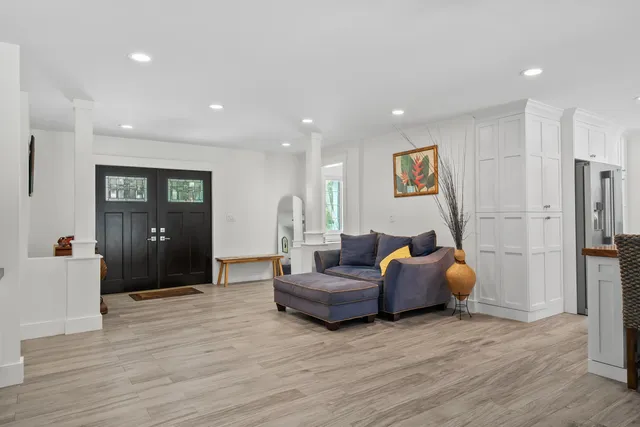a room view with wooden floor and windows