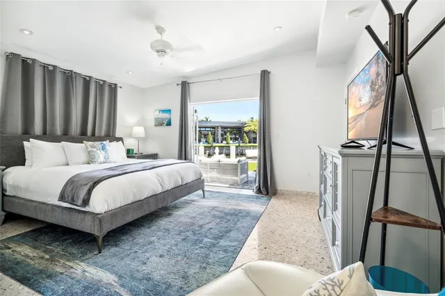 a bedroom with a bed a fireplace and a large window