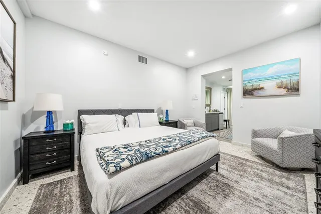 a bedroom with a bed and a couch