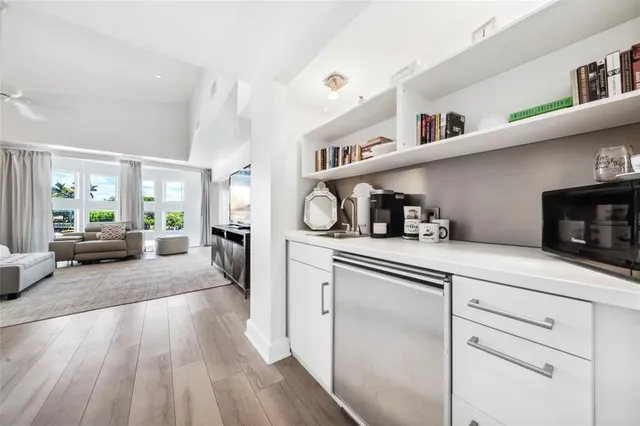 a kitchen with cabinets and wooden floor