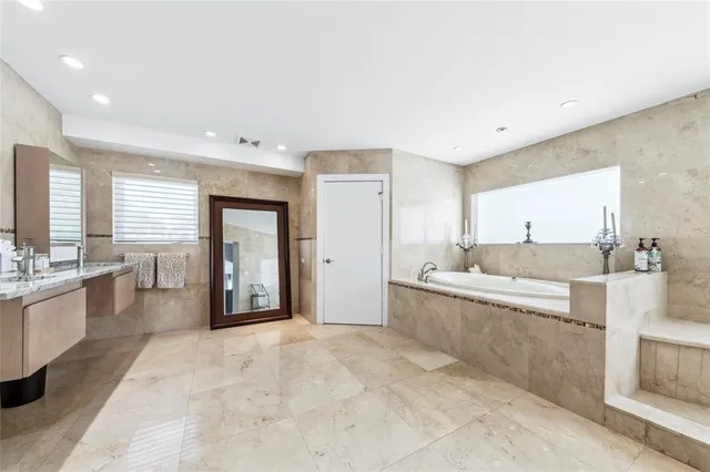 a large white kitchen with a large window
