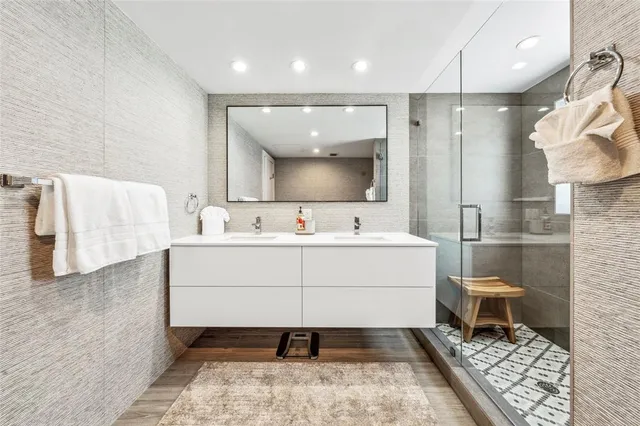 a bathroom with a sink mirror and toilet